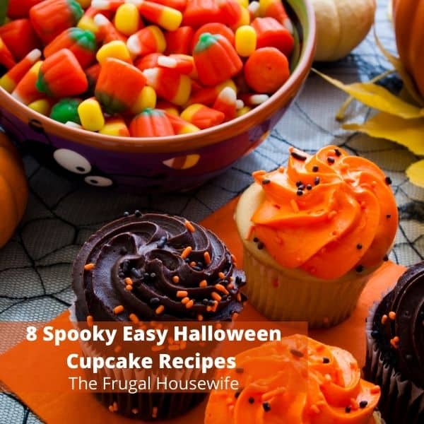 Cupcakes covered in orange and brown frosting beside a bowl of Halloween candy.