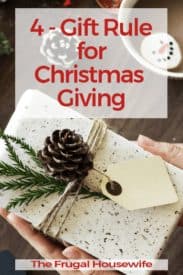Present wrapped in while paper with pinecone decoration and the title of 4-gift Rule for Christmas Giving by The Frugal Housewife