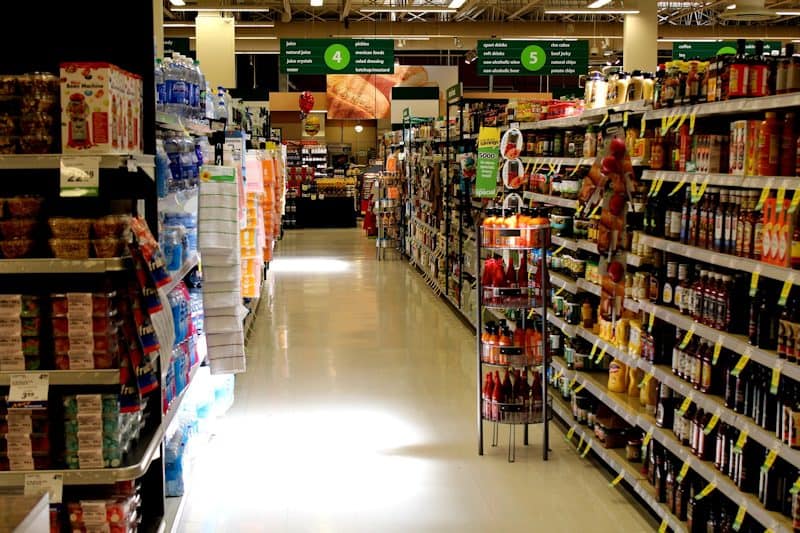 Grocery store aisle with bottles on the right side.