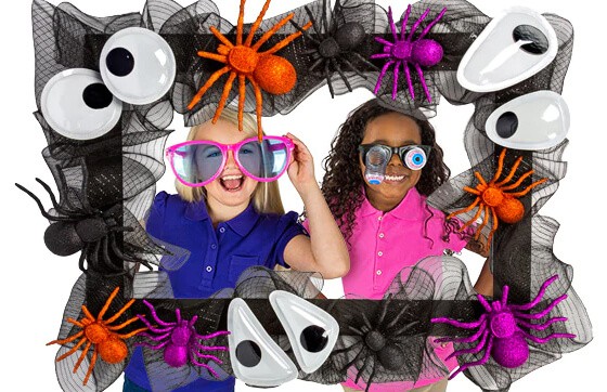 Large frame decorated with large eyes and spiders and black see through ribbon