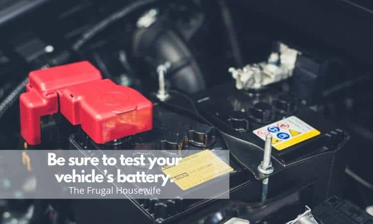 Black car battery with red connector and silver post standing up on one side. Used for Winter Car Care Tips by The Frugal Housewife.